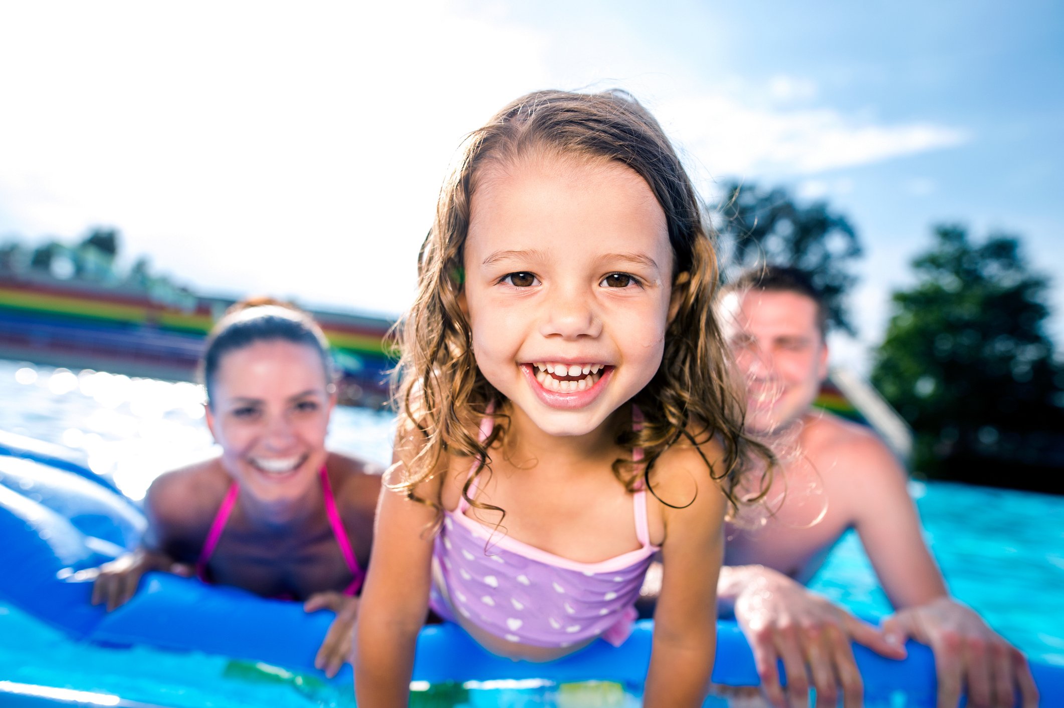 Happy family enjoying pool because they followed pool opening checklist