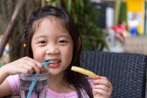 young child enjoy water and a snack
