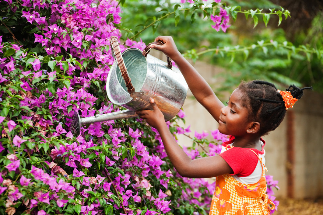 young girl water flowers 