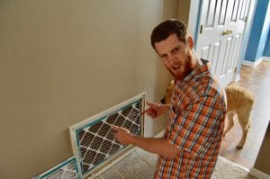 young guy disgusted by air filter