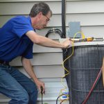 man checking on his air conditioning