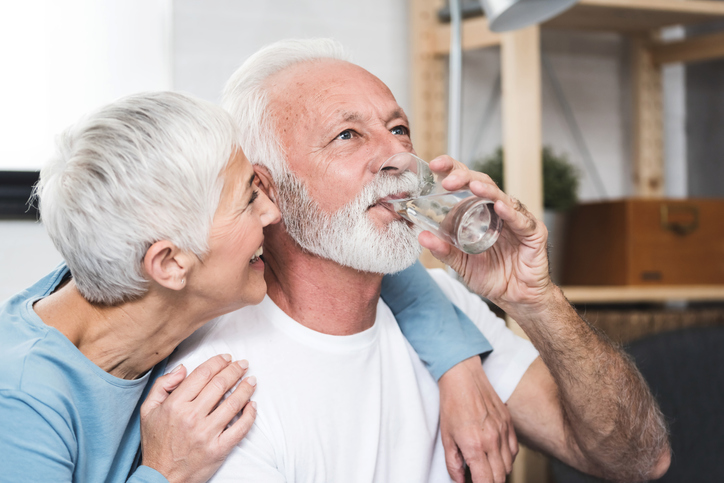 older couple enjoying water from best water filtration system