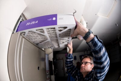 Filter installation in furnace demonstration by a handyman