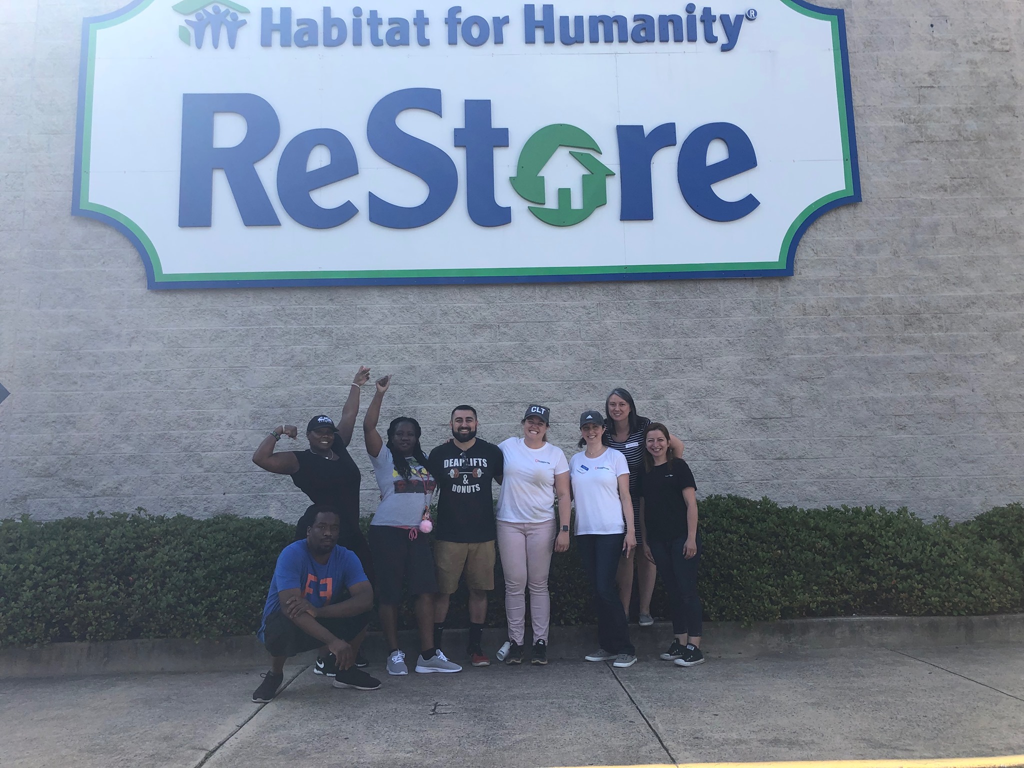 Filters Fast employees in front of ReStore sign.