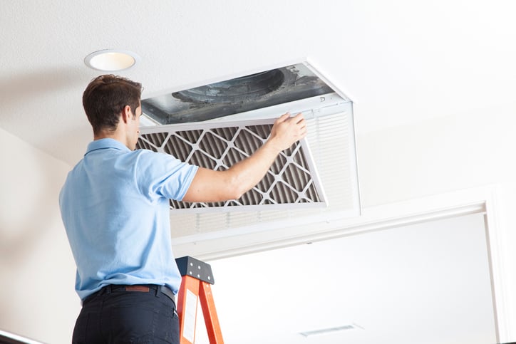 man protecting home in the winter with good air filtration habits